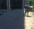 landscaper curbing asphalt pad